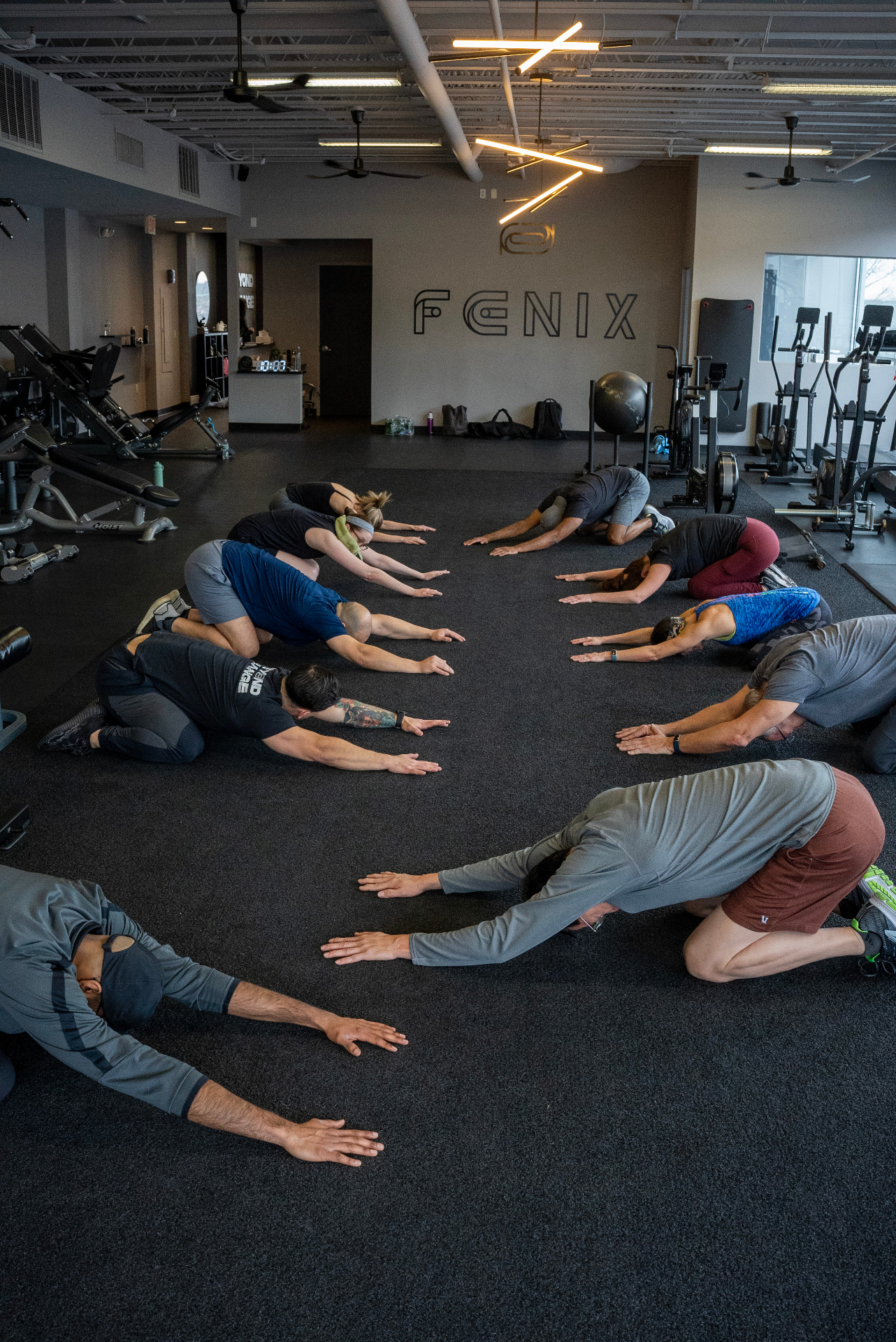 A group class stretching together on the FENIX gym floor in Englewood, NJ